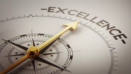 A compass pointing towards the word Excellence 